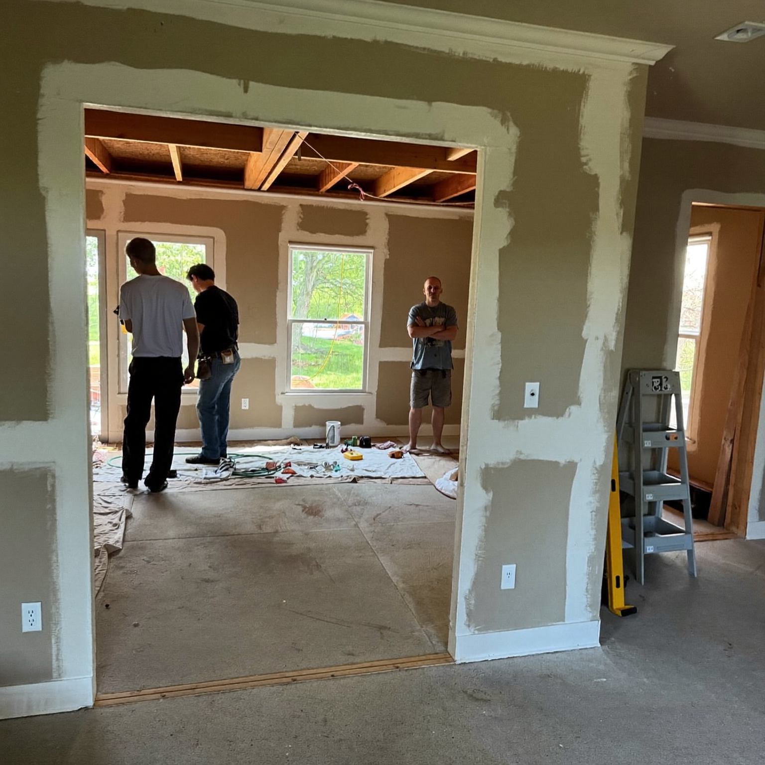 Burnsville, MN drywall and remodeling crew reviewing project photos used on their new website