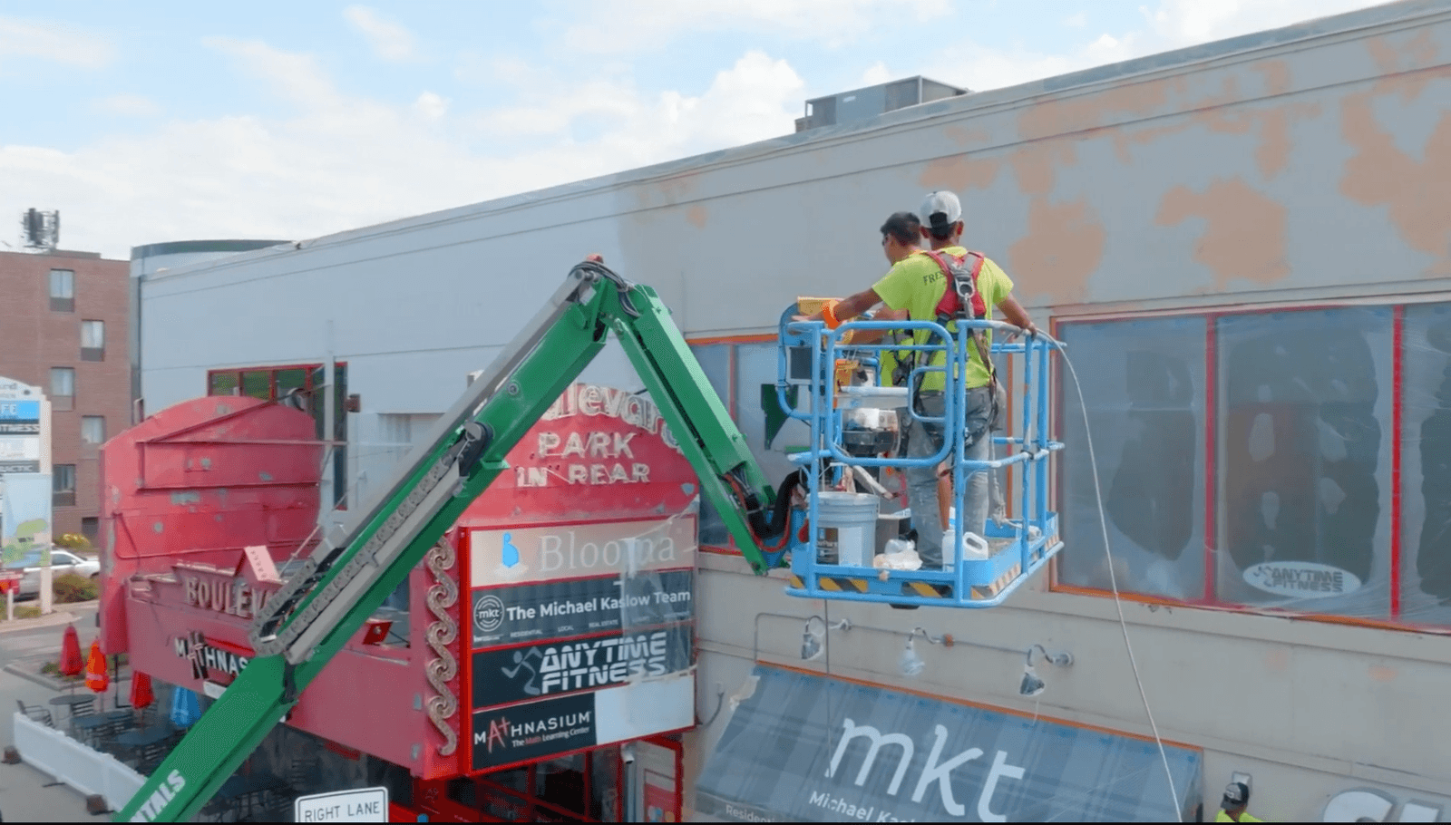 Commercial painting company, high work, team painting while on boom lift